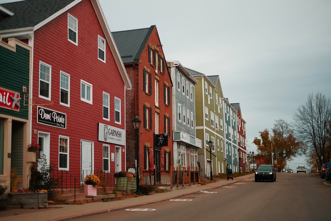 a-row-of-houses-on-a-street-with-a-car-parked-on-the-side-of-the-nctvdftpgr4