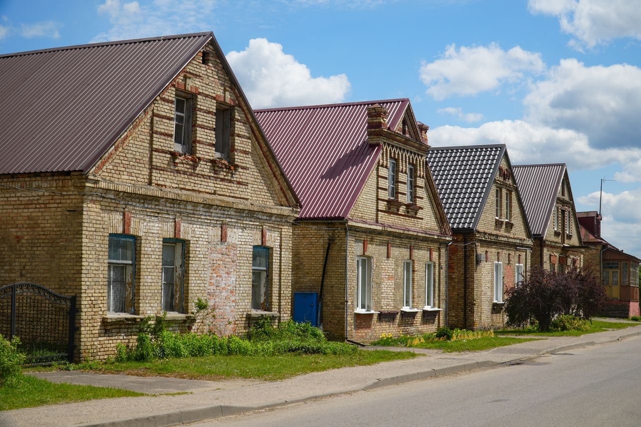 The Art of Drawing Readers In: Your attractive post title goes here Charming brick houses with gable roofs on a sunny day in Grodno Region, Belarus.