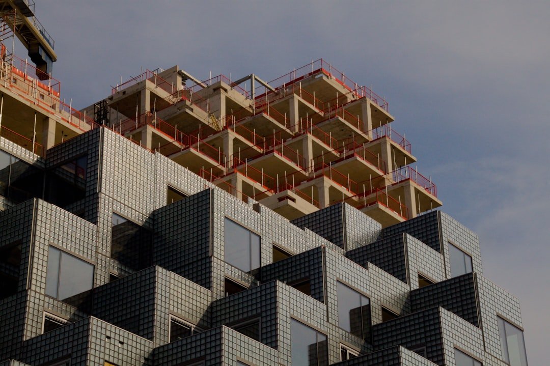 about-01 modern-building-with-angular-facade-under-construction-against-sky-h3bvom5ukbs