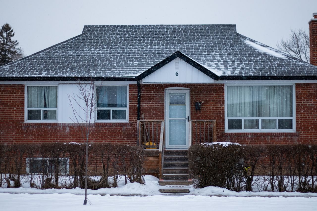 client-satisfaction-img A suburban brick house in Toronto covered with snow on a winter day.